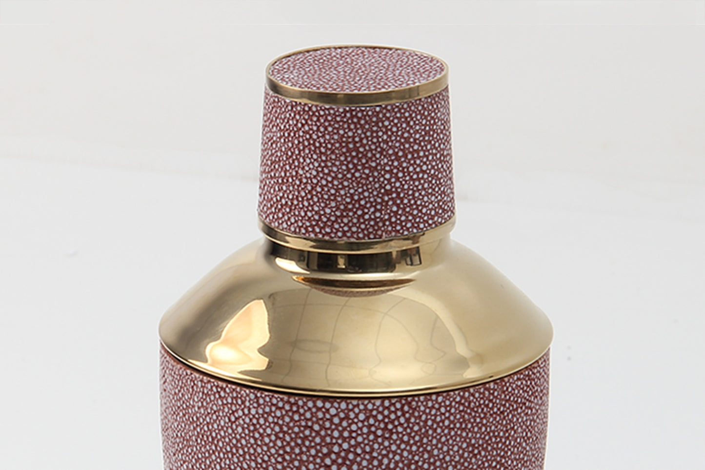 Close-up of coral shagreen texture and shaker lid