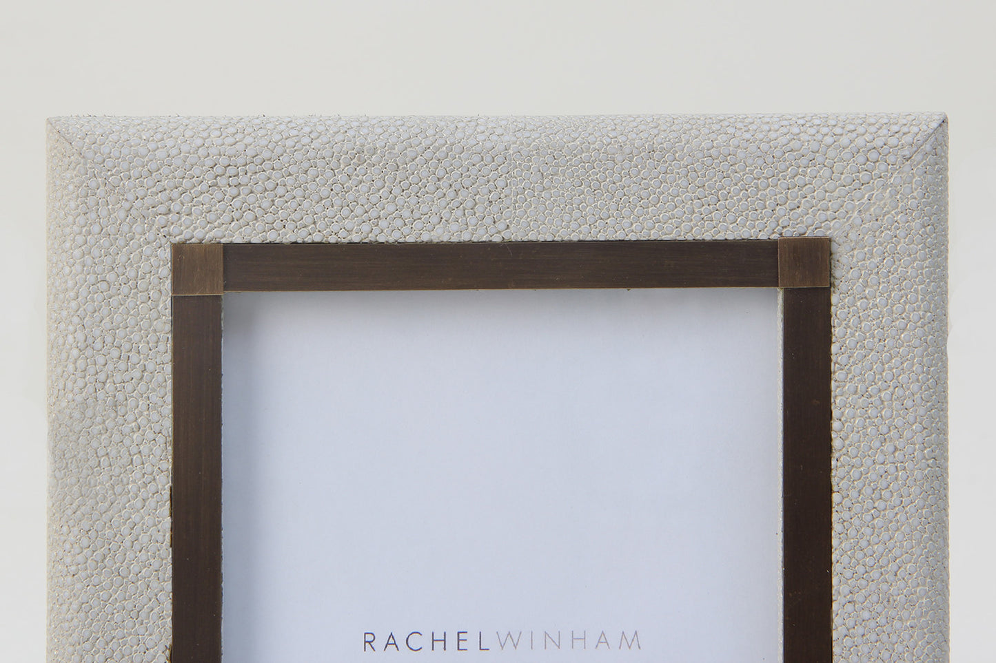 Close-up of luxury 6x4 white shagreen photo frame with antique brass detailing