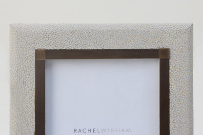 Close-up of luxury 6x4 white shagreen photo frame with antique brass detailing