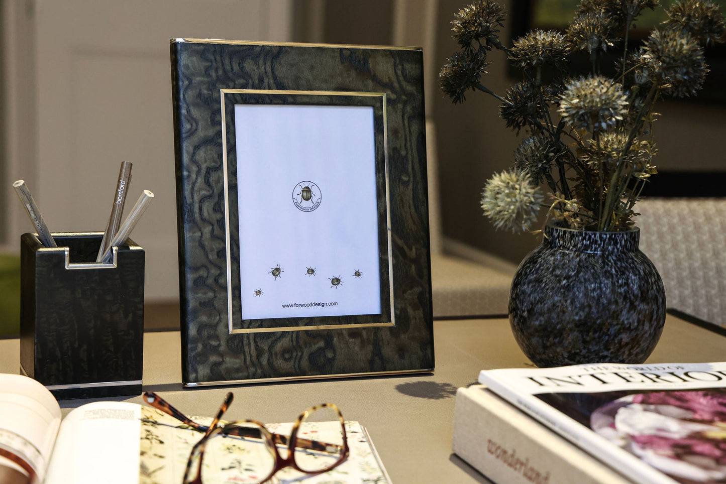 A stylish Tamo Ash ink photo frame with a stainless steel trim